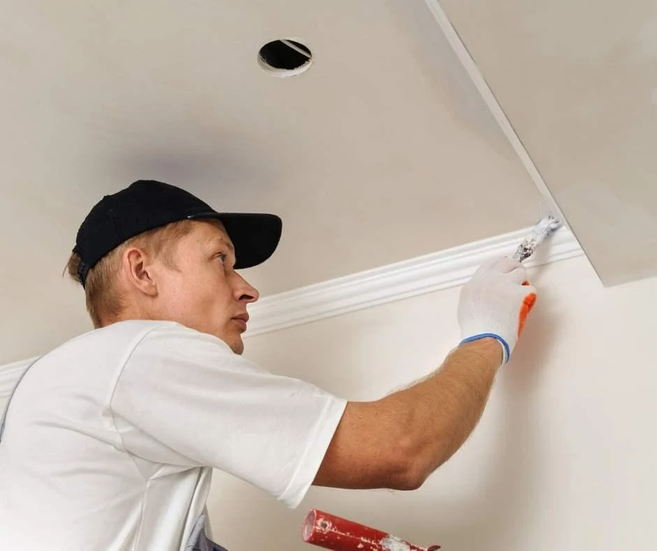 Plasterer installing a cornice